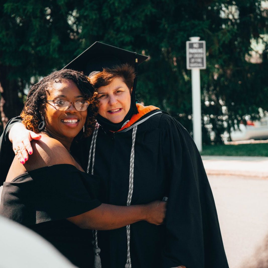2 women hugging after graduation